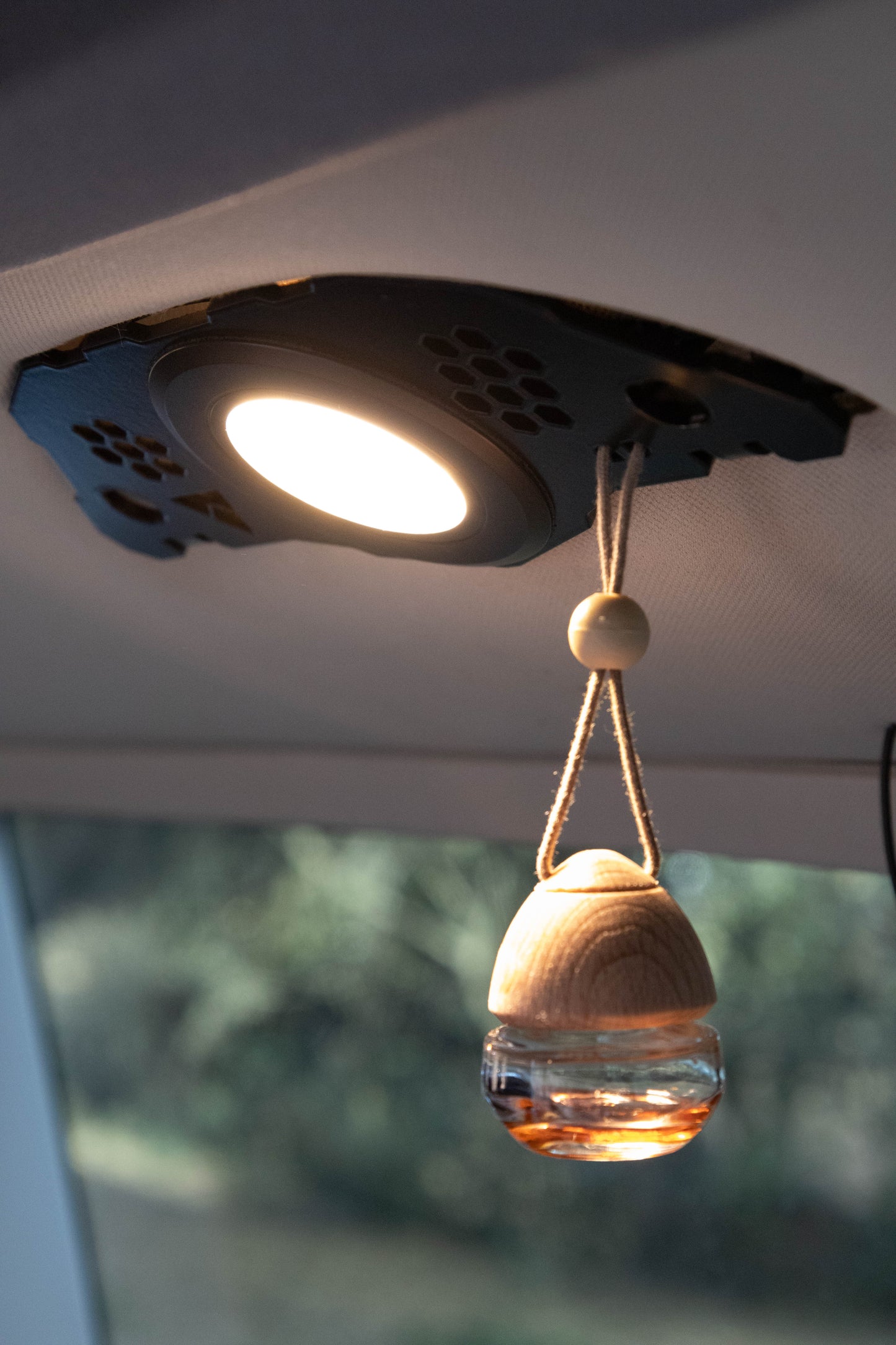 LightKarrier switched on and holding an air freshened using its mount holes.